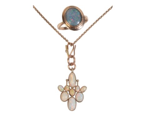 AN OPAL PENDANT NECKLACEin 9ct gold, the pendant set with nine opals held in bezel settings, suspended from a jump loop and t