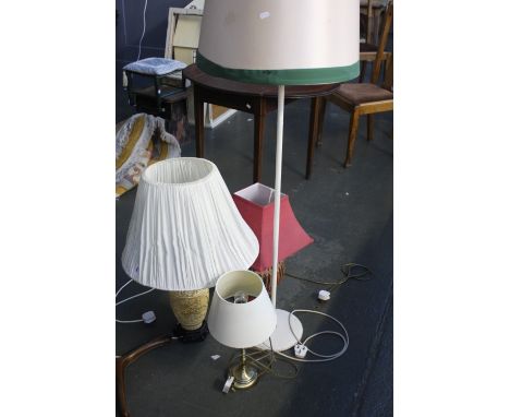 A painted metal and brass standard lamp with a Chinese style carved resin lamp base and shade with a bulboud red lamp base wi