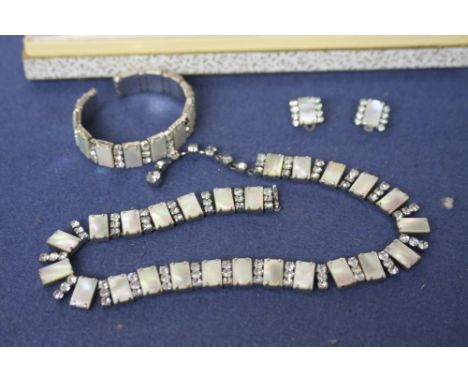 A ladies jewellery set of imitation diamond and mother of pearl alternating necklace, bangle and earrings