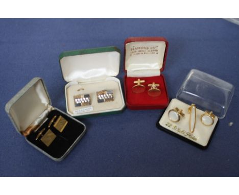 Four pairs of cased cuff links, one mother of pearl set, the others with engine turned decoration