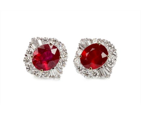 PAIR OF TREATED RUBY AND DIAMOND EARRINGS, the oval rubies, with evidence of treatment, surrounded by round brilliant and bag