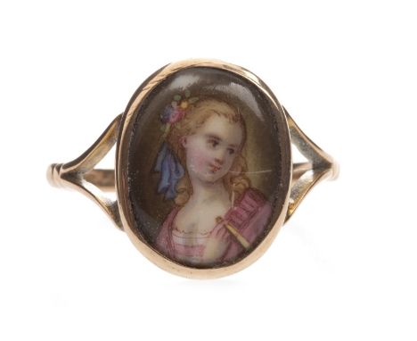 PORTRAIT MINIATURE RING, set with an oval portrait of a young woman looking right, 16mm high, on bifurcated shoulders, marked