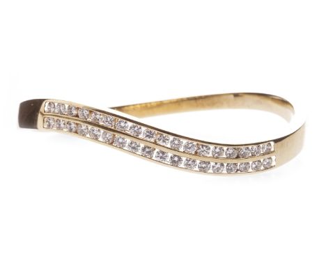 DIAMOND SET BANGLE, of waved form, channel set with two rows of brilliant cut diamonds totalling approximately 3.60 carats, i