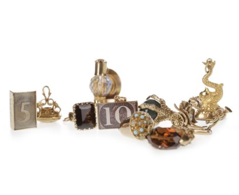GROUP OF GOLD CHARMS, including a rickshaw and a miners lamp, some marked for nine carat gold, 45g gross