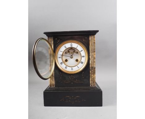 A black slate and marble mantel clock with eight-day striking movement, engraved decoration, white metal dial and Roman numer