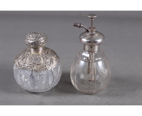 A late 19th century silver topped and cut glass scent bomb, 4 1/4" high, and an early 20th century silver topped atomiser 