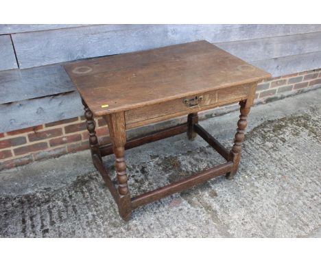 A late 18th century oak centre table, fitted one drawer, on bobbin turned and stretchered supports, 35" wide x 23" deep x 28"