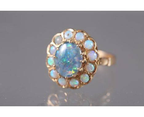 A yellow metal and opal cluster ring, size O, 4.7g 