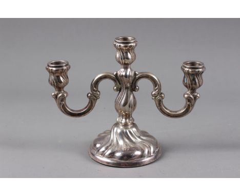 A Scandinavian white metal three-light candelabra with scrolled and spiral fluted design, on circular base, stamped 835, 7 3/