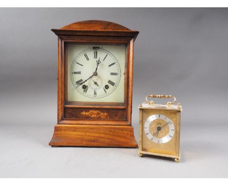 An early 20th century mahogany and inlaid arch topped mantel clock with enamelled dial and Roman numerals, 11 1/2" high, and 