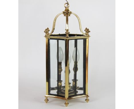 A brass hexagonal hall lantern, with turned finials, 44cm