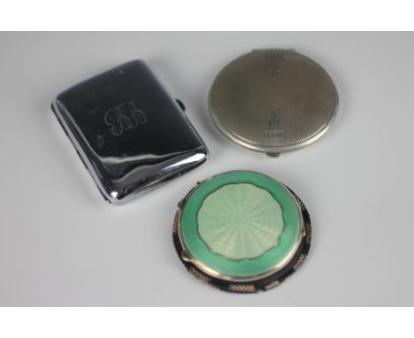 A silver and green enamel circular compact, Birmingham 1941, an Art Deco circular silver compact, Birmingham 1932, and a silv
