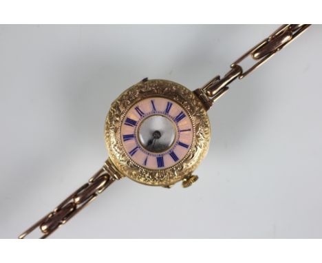 A lady's 18k half hunter watch, with pink guilloche enamel chapter ring with blue Roman numerals, enclosing white enamel dial
