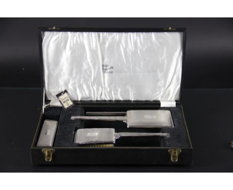 A silver four piece dressing table set, initialled and with engine turned decoration, Birmingham 1964, in fitted case, with t