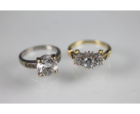 An aquamarine and diamond triple cluster ring, the three graduated aquamarines, within a diamond set surround, all set in whi