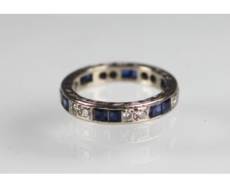 A sapphire and diamond full eternity ring, designed as alternating panels of two calibre cut sapphires and two brilliant cut 