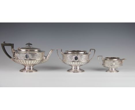 A 19th century Elkington & Co silver plated three piece tea set, of oval Adam design, decorated throughout with harebell swag