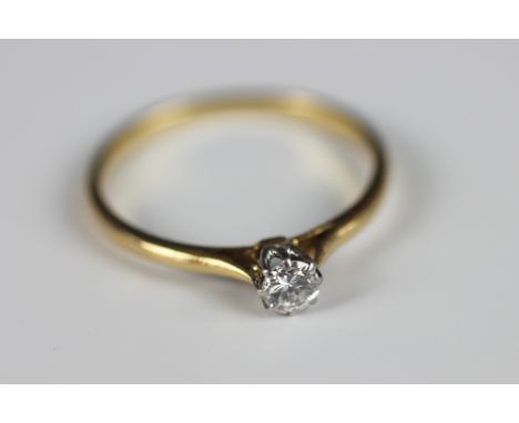 A diamond solitaire ring, the brilliant cut diamond within eight claw white metal setting to the tapering shoulders and plain