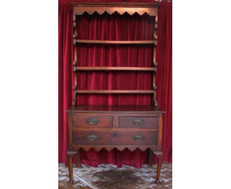 A George III style oak high back dresser, with three shelf back above two short and one long drawer, with shaped apron on cab