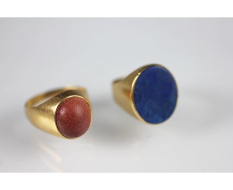 A Lapis lazuli set gold signet ring, weight 8.1gms and a goldstone set ring, stamped 'K18', weight 7.5gms (2)