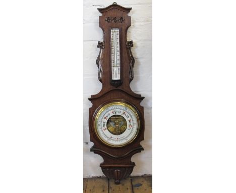 An Edwardian carved oak aneroid barometer, decorated with flowers, 91cm