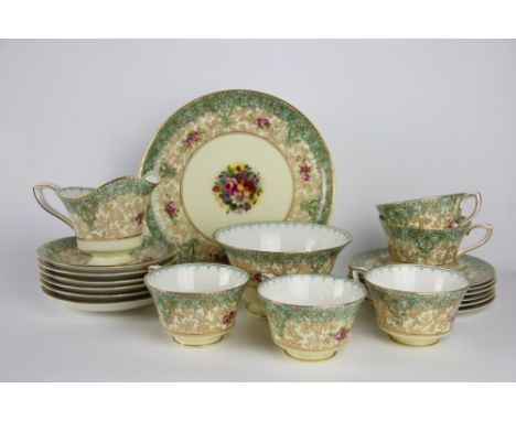 A Royal Worcester twenty one piece bone china tea service, painted with floral sprays by J Goodwin, with a gilt and green tra