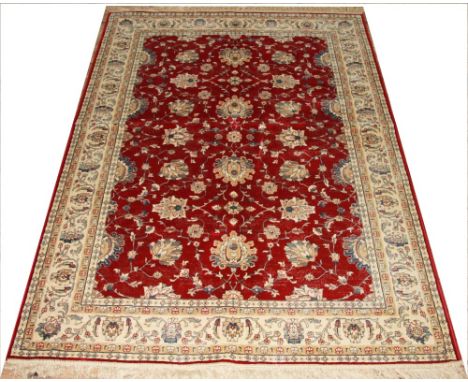 A Kashmir Ziegler carpet, worked with an all over foliate design against a red ground, 228cm x 157cm