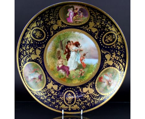 A Vienna porcelain charger, decorated with a titled scene 'spring awakening' (at fault), with a Vienna trinket box and other 