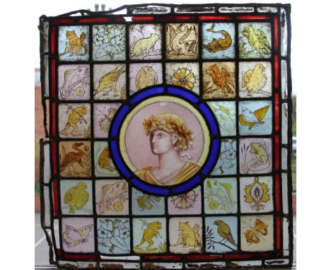 A pair of late 19th centuery stained glass panels, each with a central roundel portrait, one of a maiden the other of a male 