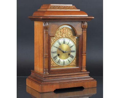 A German walnut 8 day mantel clock, the domed, glazed door enclosing silver Roman numeral chapter ring and matted centre with