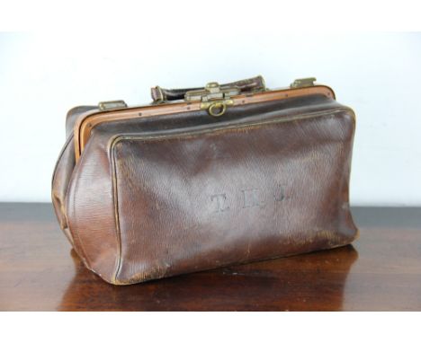 A leather and brass Gladstone type bag, initialled 'THJ' a red hunting jacket, two Victorian tiles, two Staffordshire pastile