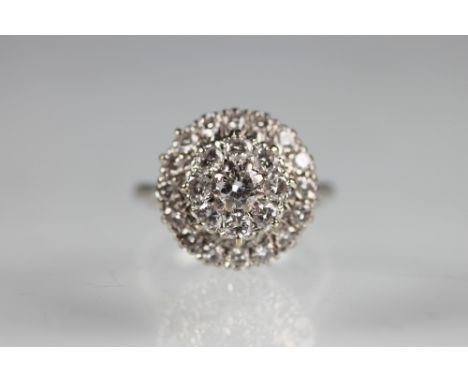 A diamond set three tier 'target' ring, designed as a central diamond, with a second tier of eight brilliant cut diamonds and