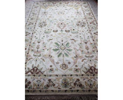 A Persian wool ground carpet, worked with an overall foliate design against a beige ground, 305cm x 197cm