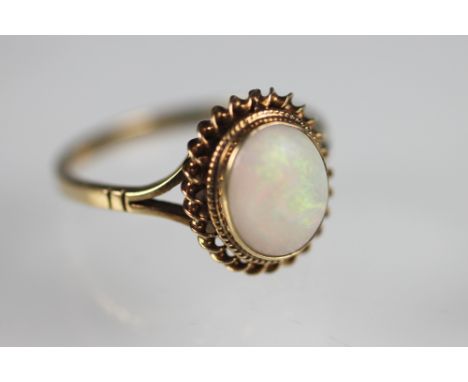 An opal set dress ring within 9ct yellow gold setting and rope twist surround, weight 2.3gms and a 9ct yellow gold eternity r