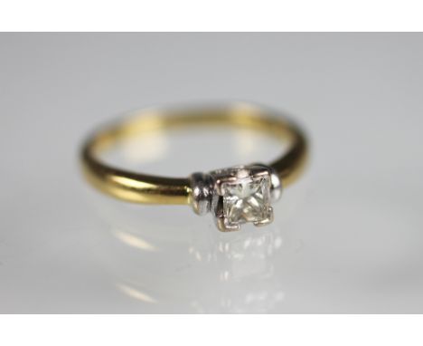 A diamond solitaire ring, the princess cut diamond within four corner, white metal setting, to the white gold shoulders and p
