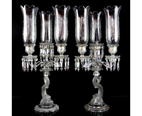 A pair of modern moulded glass three light candelabra, of early 19th century design, with foliate decorated storm shades on d