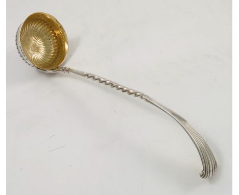 A Victorian silver ladle, with gadrooned gilt wash bowl, twist to the handle, with gadrooned terminal, London 1880, maker Wal