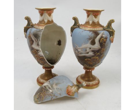 A pair of Royal Worcester vases, decorated with swans in flight over reeds to the front and a swallow in flight to the revers