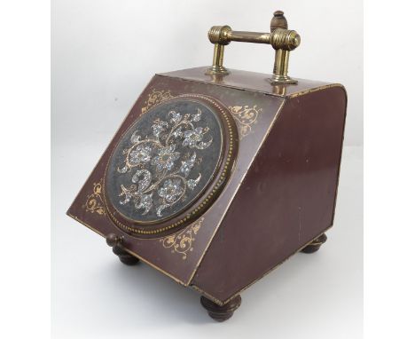 A late 19th century red japanned coal bucket, the sloping front with a circular panel decorated with mother of pearl flower h