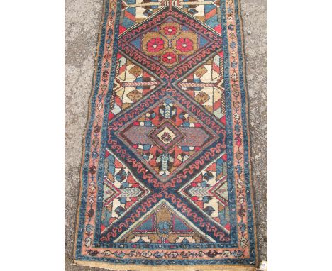 An Eastern design runner, decorated with five diamonds to the field, 111ins x 28ins 