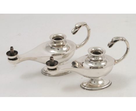 A pair of silver aladdin lamp chamber sticks, with bird mask handles, one handle af, Birmingham 1935