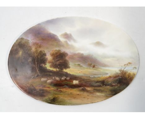 A Royal Worcester oval porcelain plaque, hand painted with a flock of sheep in a highland landscape with trees, mountains and
