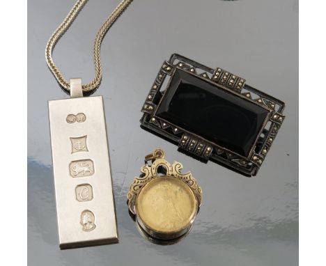 An enamelled coin mounted as a pendant, together with a silver ingot pendant on a chain, an enamelled butterfly brooch, an en