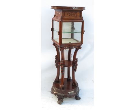 An inlaid Oriental cabinet on stand, the circular top carved and inlaid with mother of pearl, over a square glazed cabinet wi