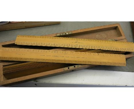 A cased set of Stanley wooden rulers, comprising eight wooden engine divided scale rulers, and six smaller rulers, missing ov