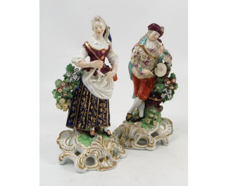 A pair of 18th century English porcelain figures, modelled as a tambour and piper and a woman playing a triangle, decorated i