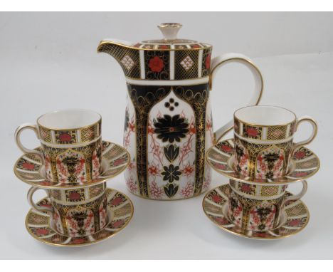 A Royal Crown Derby part coffee set, comprising coffee pot, four cans and six saucers, all decorated in the 1128 Imari patter