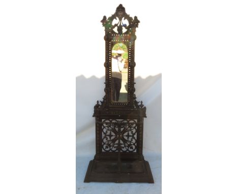 A Coalbrookdale style hall stand, moulded with lions mask and flowers over a central mirror with pierced base below, having '