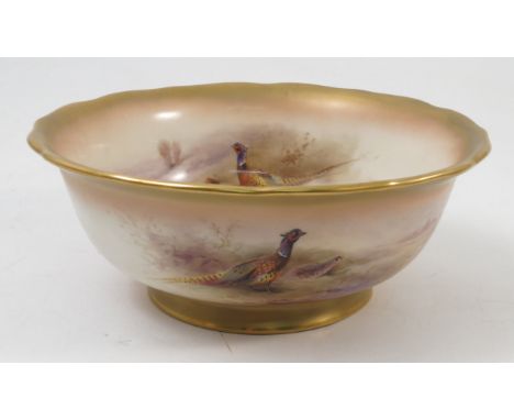 A Royal Worcester bowl, decorated to the interior and exterior with pheasants in landscape by Jas Stinton, with gilt shaped e