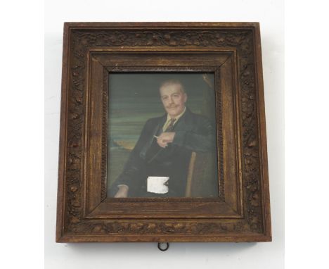 A watercolour on ivory portrait, of a seated man wearing a suit, smoking a cigarette, inscribed verso, Sir Basil Thorndyke, 6